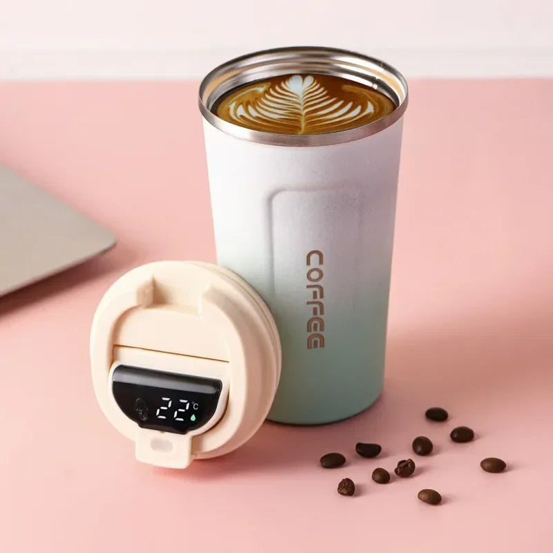  insulated coffee cup with digital thermometer on a pink background