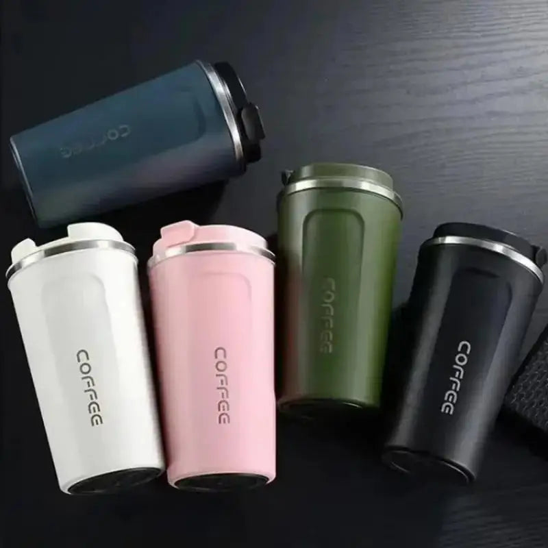 Set of colorful coffee tumblers with 'COFFEE' text on a dark surface