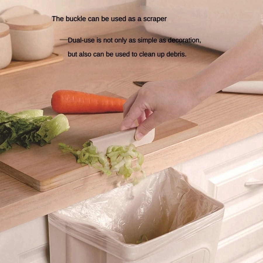 Person using a wooden buckle to clean up debris on a kitchen counter with text about its dual-use as a scraper.