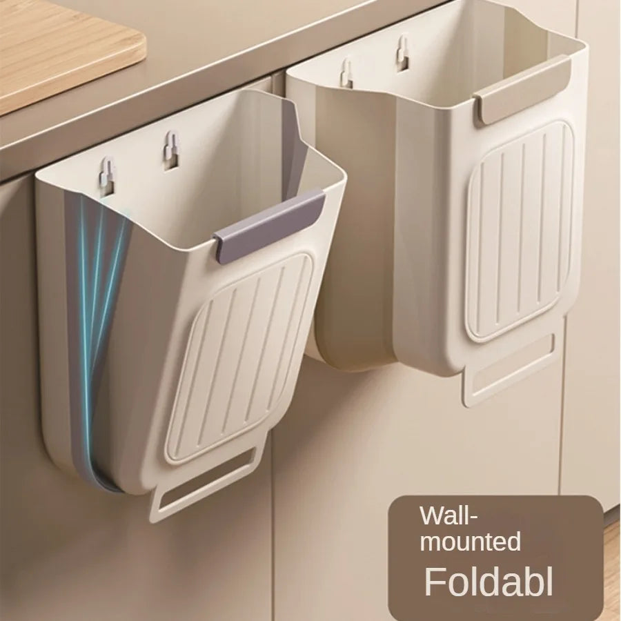 Wall-mounted foldable trash bins attached to a kitchen cabinet.