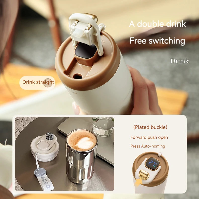 Double-walled insulated mug with a plating buckle mechanism, held by a hand.