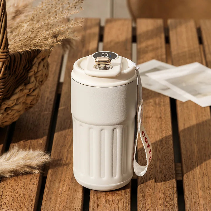White ceramic mug with digital display on a wooden surface