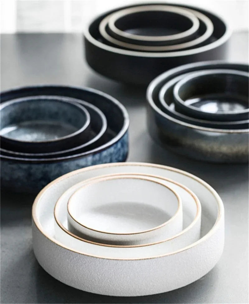 Set of ceramic bowls in various sizes on a gray surface