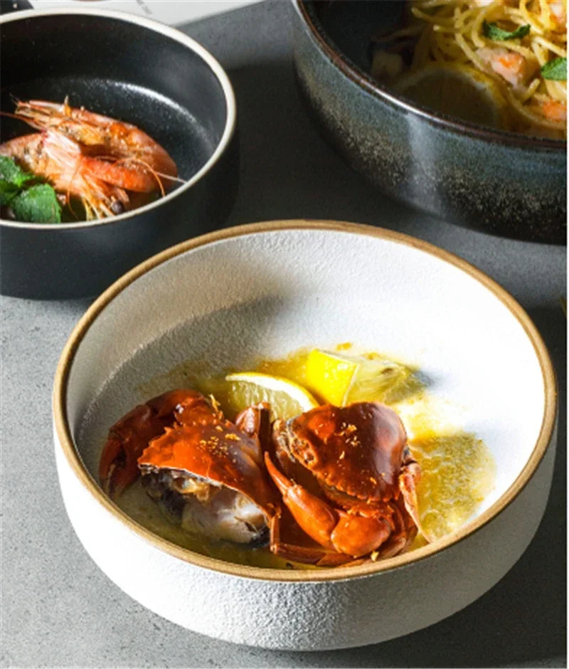Bowl of soup with crab and lemon slices on a gray surface