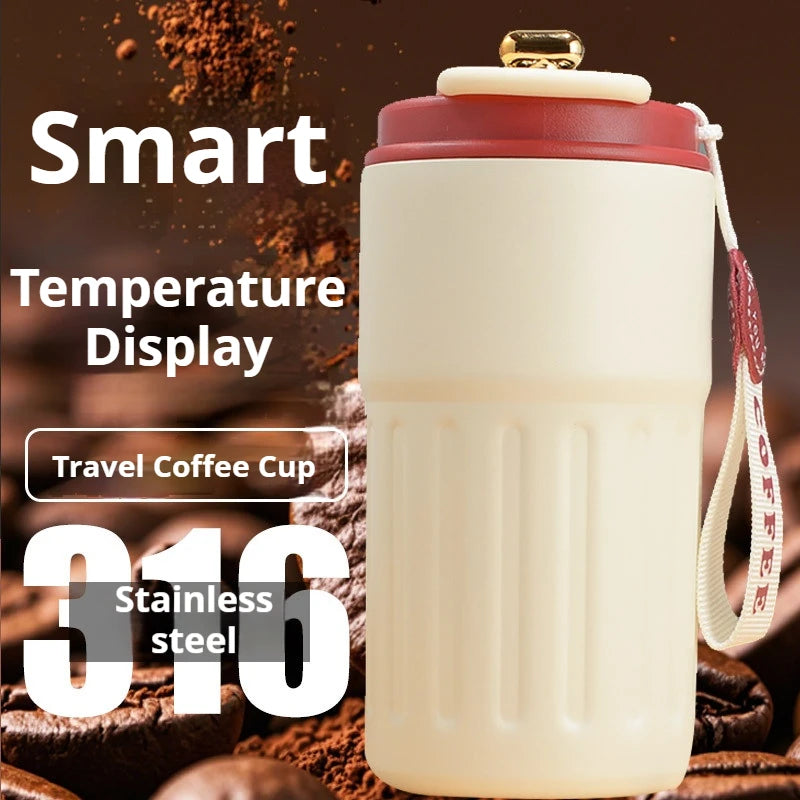 Travel coffee cup with smart temperature display and stainless steel feature, surrounded by coffee beans and grounds.