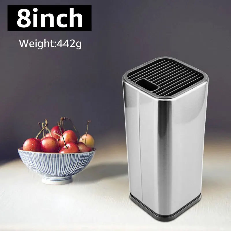 Small metallic trash can next to a bowl of cherries on a neutral background