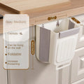 Wall-mounted trash bin with hanging mechanism on a wooden surface