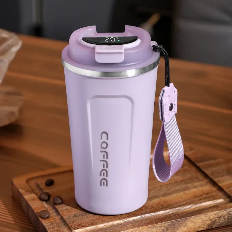 Purple coffee tumbler with digital display on a wooden surface