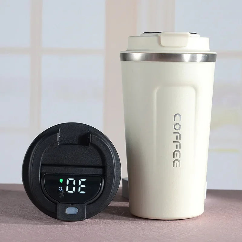 White coffee tumbler with digital temperature display on a neutral background
