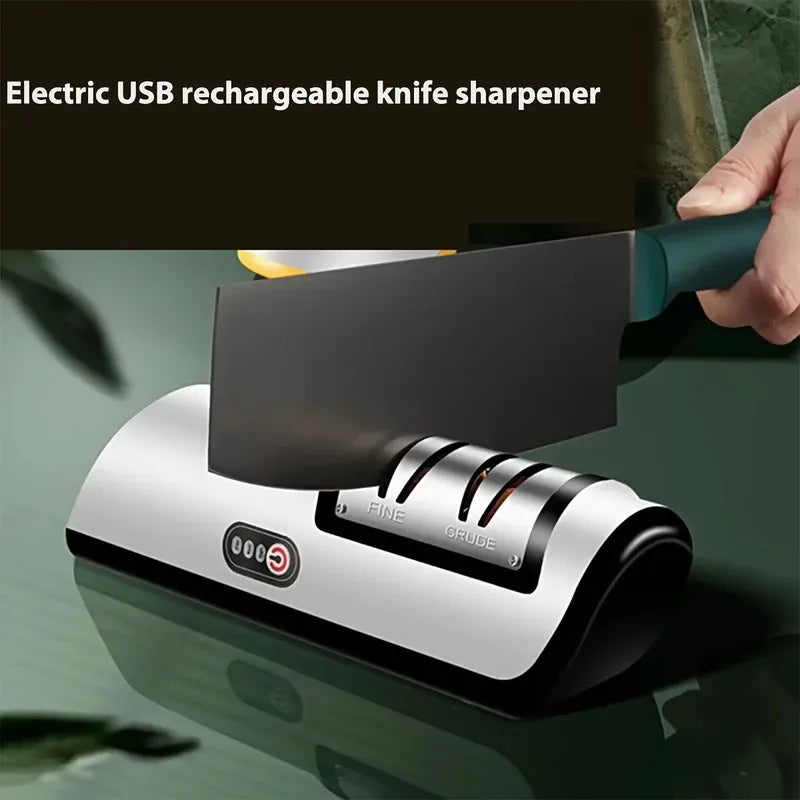 Electric USB rechargeable knife sharpener with a knife being sharpened on a reflective surface.